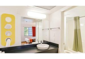 a bathroom with a sink and a mirror at Motel 6-Carlsbad, CA Beach in Carlsbad