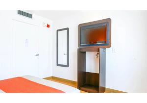 a room with a flat screen tv on a wall at Motel 6-Carlsbad, CA Beach in Carlsbad +23 photos