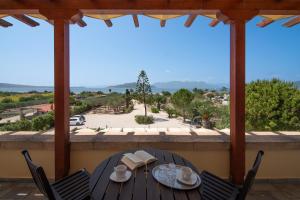 a table and chairs on a balcony with a view at Villa Ersilia in Egina