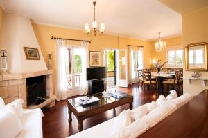 a living room with a couch and a fireplace at Villa Ersilia in Egina