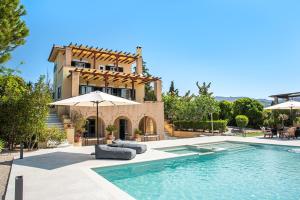 a house with a swimming pool in front of a building at Villa Ersilia in Egina