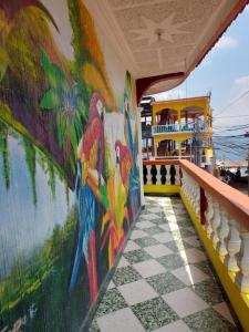a mural of parrots on the side of a cruise ship at Hotel Casa Ramos in Panajachel