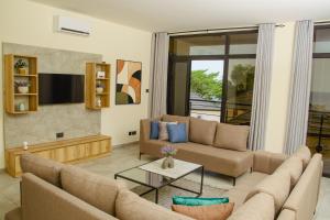 a living room with a couch and a table at Venue 360 Hotel in Freetown