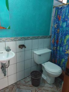 a bathroom with a toilet and a sink at Hotel Casa Ramos in Panajachel