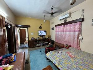 a child sitting in a bedroom watching a tv at Rishi niwas in Darbhanga