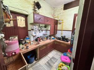 a kitchen with wooden cabinets and a counter top at Rishi niwas in Darbhanga