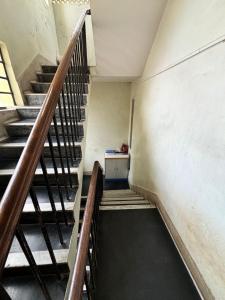 an empty stairs in an old building with a table at Rishi niwas in Darbhanga