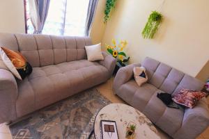 a living room with a couch and two couches at The Nest Apartment Darad in Ukunda Airport