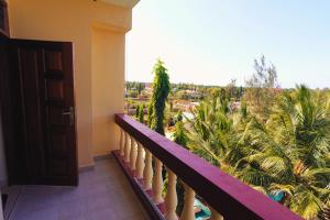 a balcony with a view of a resort at The Nest Apartment Darad in Ukunda Airport