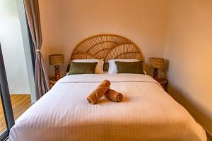 two teddy bears sitting on top of a bed at Les Clos de L Albatros in Saint-Paul