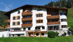 an apartment building with balconies on a hill at Appartements Tschol Martin in Sankt Anton am Arlberg