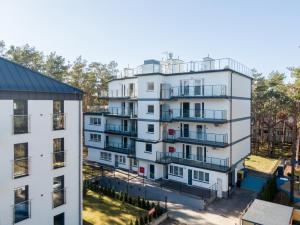 an aerial view of a white apartment building at Nadmorski Bursztyn - Błękitna in Rowy
