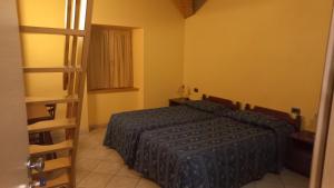 a bedroom with a bed and a ladder in it at Albergo Coira Antica Dimora in Santa Brigida