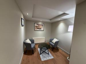a living room with two chairs and a table at Right Choice by 3 Crowns in Dundee