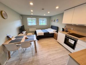 a room with a bed and a kitchen with a table at Fjord studio in Sunde