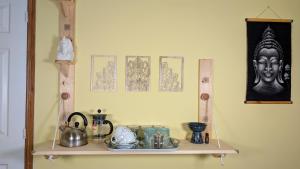 a shelf with a statue on top of it at Hot Tub Home - Stay in Stoke on Trent