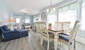 a living room with a table and a blue couch at Beach Block Ocean Views steps from the boardwalk in Ocean City
