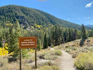 a sign that says no snakes enter a walking path at Pines 2167 by SummitCove Lodging in Colorado in Keystone