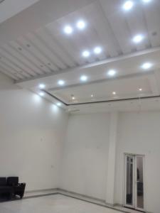 a room with a white wall with lights on it at Kanti empire in Dhaulpur
