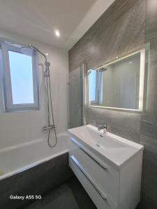 a bathroom with a white sink and a mirror at Lomnica Lodge in Vysoké Tatry +15 photos