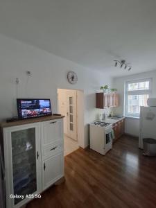 a kitchen with a tv on top of a counter at Lomnica Lodge in Vysoké Tatry