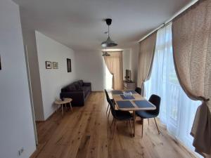 a living room with a table and a couch at Moderne Sauerhof Apartments in Baden