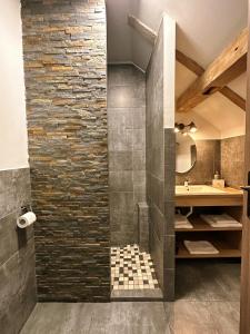 a bathroom with a stone wall and a shower at TimHouse in Timişoara +70 photos