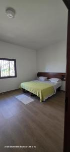 a white room with a bed and a window at Tata Khane in Ngaring