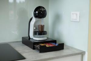 a coffee maker on a counter with a drink at Testa tra le Nuvole - Attico con Terrazza panoramica in centro in Novi Ligure