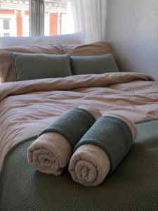 a bed with two towels on top of it at Charming room central Oslo in Oslo