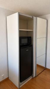 a kitchen with a refrigerator in a room at Charming room central Oslo in Oslo