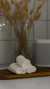 a vase with flowers and a towel on a cutting board at Charming room central Oslo in Oslo