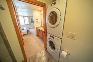 a bathroom with a washer and dryer in a house at Pines 2147 by SummitCove Lodging in Colorado in Keystone