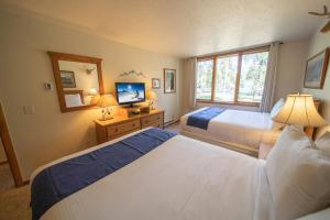 a hotel room with two beds and a television at Pines 2147 by SummitCove Lodging in Colorado in Keystone +33 photos