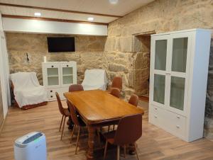 a dining room with a wooden table and chairs at Casa rústica busto in Armentera