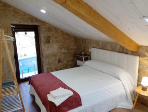 a bedroom with a white bed and a window at Casa rústica busto in Armentera +49 photos