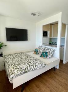 a bedroom with a bed with a flat screen tv at Splendid view Apartment in Cannes in Cannes +42 photos