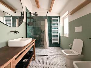 a bathroom with a sink and a toilet and a mirror at Ancona design apartment in Ancona +16 photos