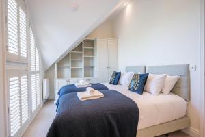 a bedroom with two beds with towels on them at Orange House, Southwold in Southwold