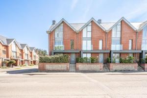 a large brick building on a street at Orange House, Southwold in Southwold