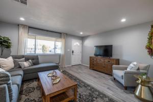 a living room with a couch and a tv at Chandler Galveston in Chandler