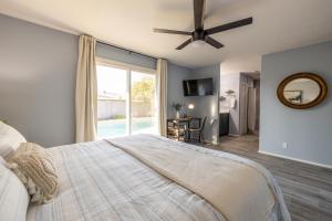 a bedroom with a large bed with a ceiling fan at Chandler Galveston in Chandler +33 photos