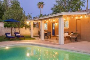 a backyard with a pool and a house with a patio at Chandler Galveston in Chandler