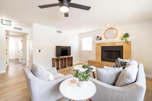 a living room with two chairs and a fireplace at Chandler Tyson in Chandler