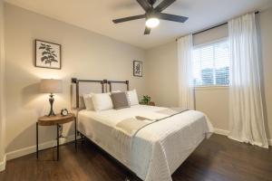 a bedroom with a bed and a ceiling fan at Chandler Tyson in Chandler +54 photos