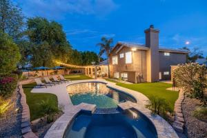 a backyard with a swimming pool and a house at Chandler Tyson in Chandler