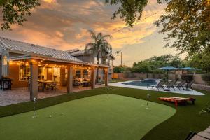 a backyard with a putting green and a house at Chandler Tyson in Chandler