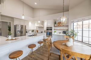 a kitchen with a wooden table and chairs at Gilbert Willow Tree in Gilbert