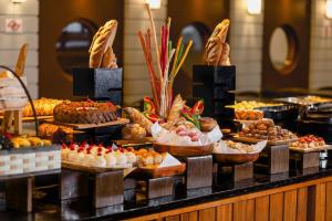 a buffet with many different types of pastries and desserts at Bourbon Convention Hotel Santos in Santos