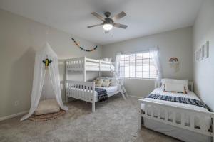 a bedroom with two white bunk beds and a ceiling fan at Gilbert Willow Tree in Gilbert +53 photos